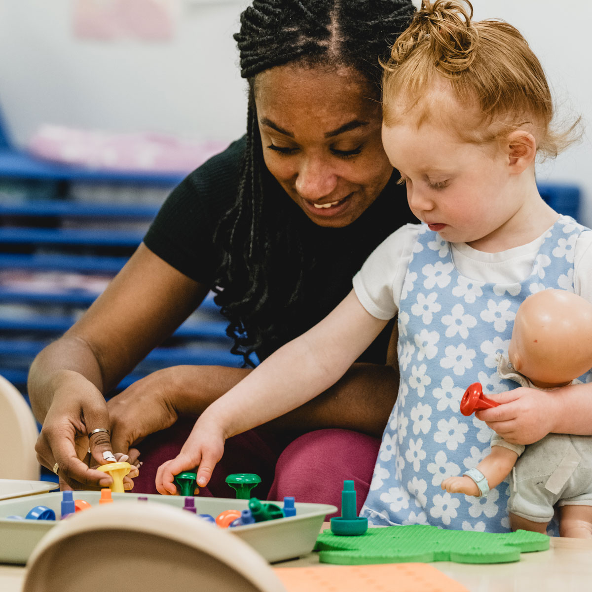 Teach and child playing